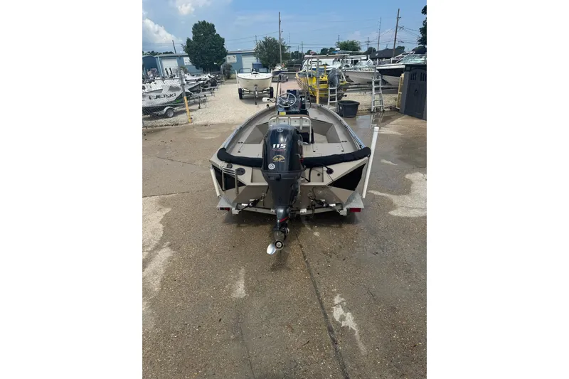 Slide: The Image of 2020 Excel 203 Bay Pro boat with outboard motor in a marina setting. - 5