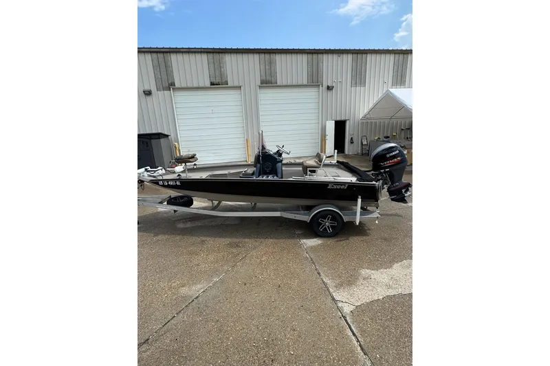 Slide: The Image of 2020 Excel 203 Bay Pro boat on trailer, parked outside a garage. - 7