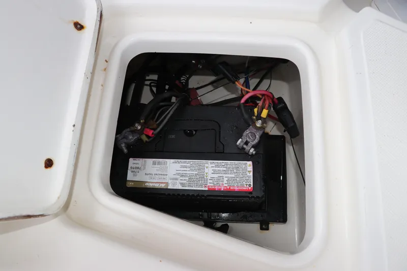 Slide: The Image of Battery compartment of a 2004 Pioneer 175 Bay Sport boat, showing wiring connections. - 11