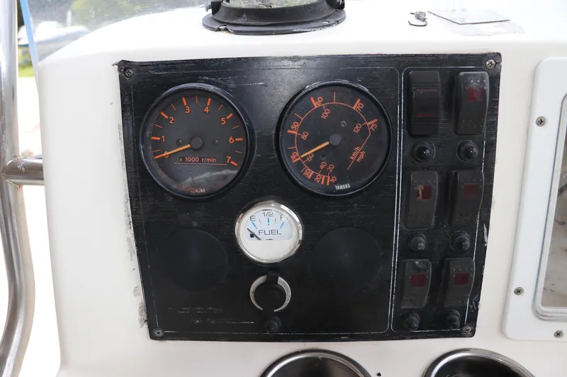 Slide: The Image of Dashboard of a 2004 Pioneer 175 Bay Sport boat with gauges and switches. - 18