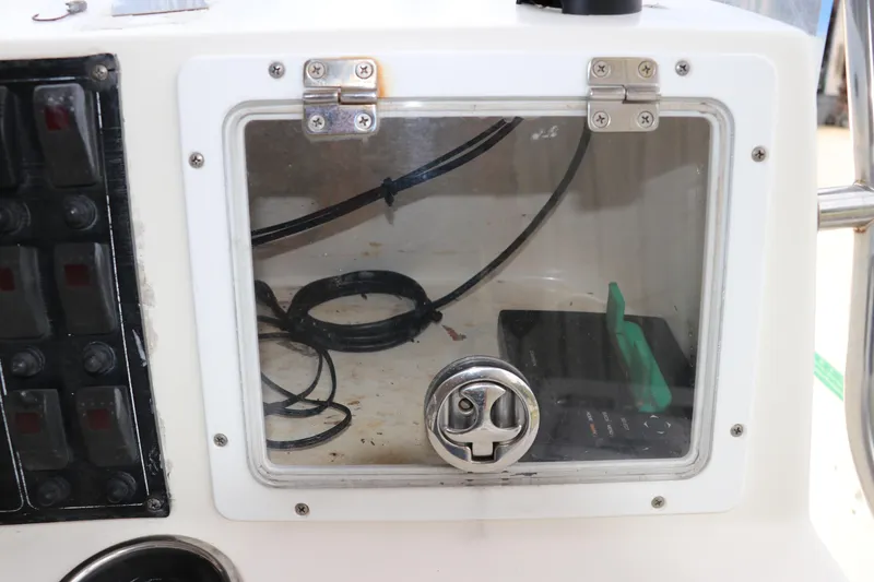 Slide: The Image of Control panel of a 2004 Pioneer 175 Bay Sport boat with wiring and switches. - 19