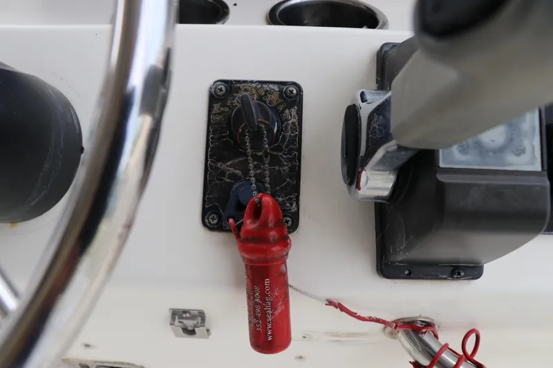 Slide: The Image of Close-up of a 2004 Pioneer 175 Bay Sport boat ignition and throttle controls. - 20