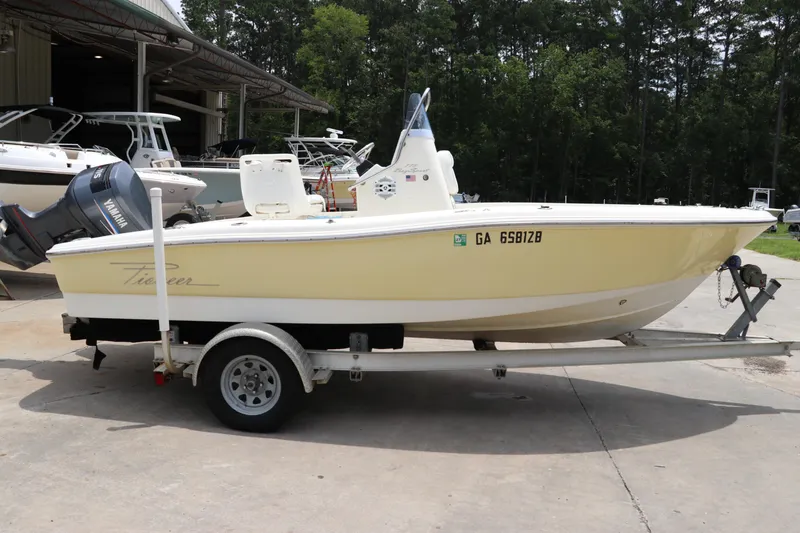 Slide: The Image of 2004 Pioneer 175 Bay Sport boat on trailer, parked outdoors near other boats. - 3
