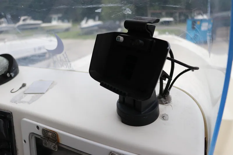 Slide: The Image of Dashboard of a 2004 Pioneer 175 Bay Sport boat with phone holder and hook. - 30