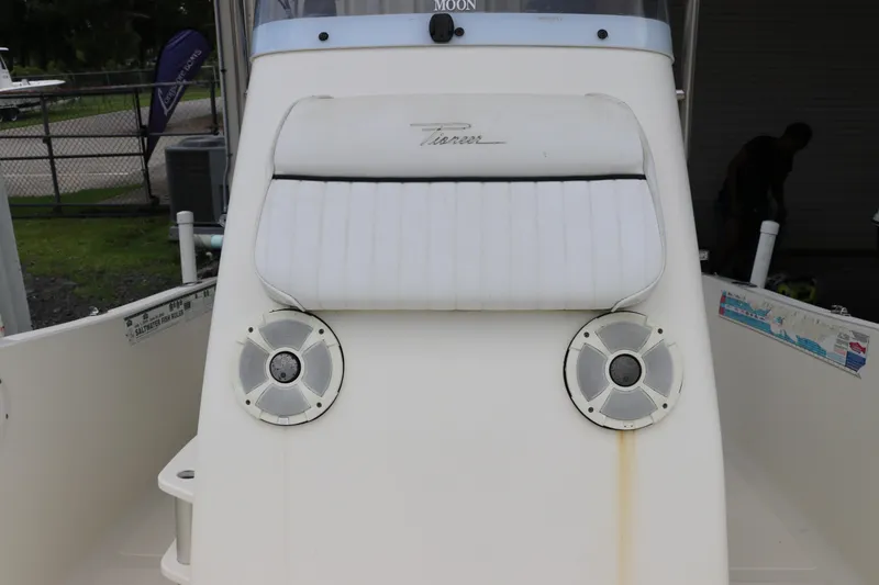 Slide: The Image of 2004 Pioneer 175 Bay Sport boat console with speakers and cushioned seat. - 32