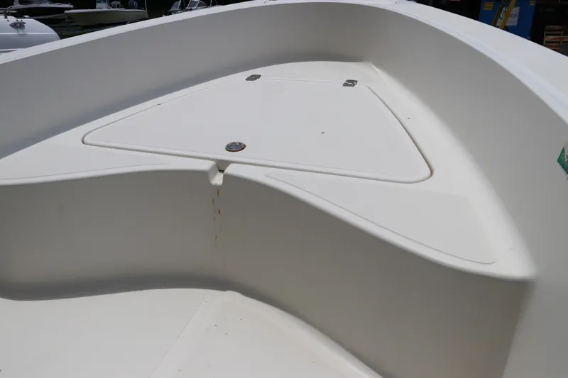 Slide: The Image of 2004 Pioneer 175 Bay Sport boat interior, featuring a clean, white storage compartment. - 34