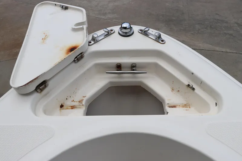 Slide: The Image of Open storage compartment on 2004 Pioneer 175 Bay Sport boat, showing rust and wear. - 38