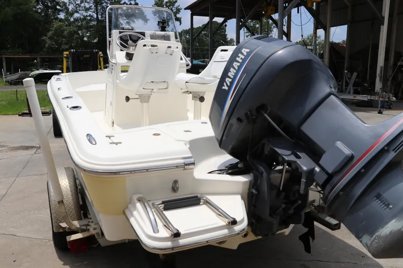 Slide: The Image of 2004 Pioneer 175 Bay Sport boat with Yamaha outboard motor, parked outdoors. - 4