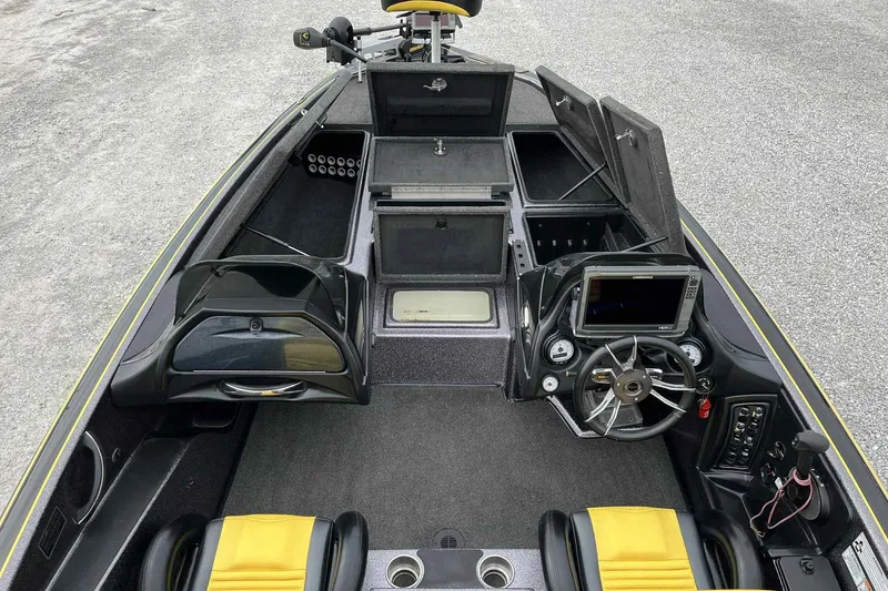 Slide: The Image of 2017 Blazer 625 Pro Elite boat interior with steering wheel, storage compartments, and yellow-accented seats. - 15