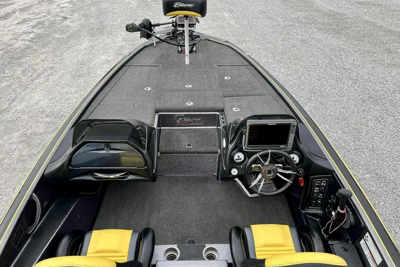 Slide: The Image of 2017 Blazer 625 Pro Elite boat interior with steering wheel, dashboard, and yellow seats. - 7