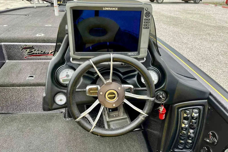 Slide: The Image of 2017 Blazer 625 Pro Elite boat dashboard with Lowrance HDS12 display and steering wheel. - 9