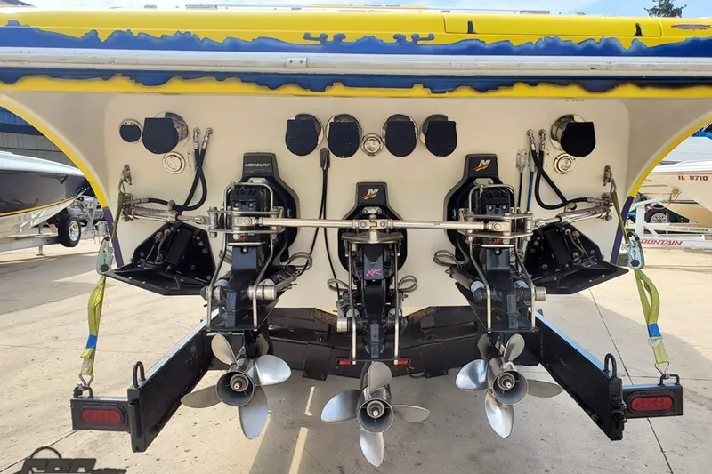 Slide: The Image of Rear view of 2001 Hustler 50 Monster boat with triple Mercury engines. - 11