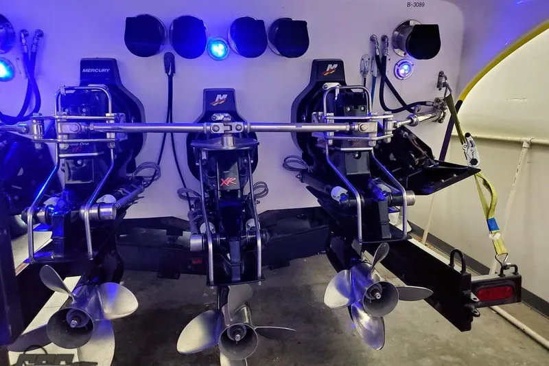 Slide: The Image of Rear view of 2001 Hustler 50 Monster boat with triple Mercury engines. - 13