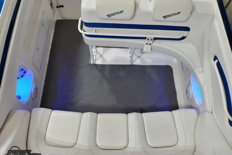 Slide: The Image of Interior of 2001 Hustler 50 Monster boat with white seating and blue LED lighting. - 17