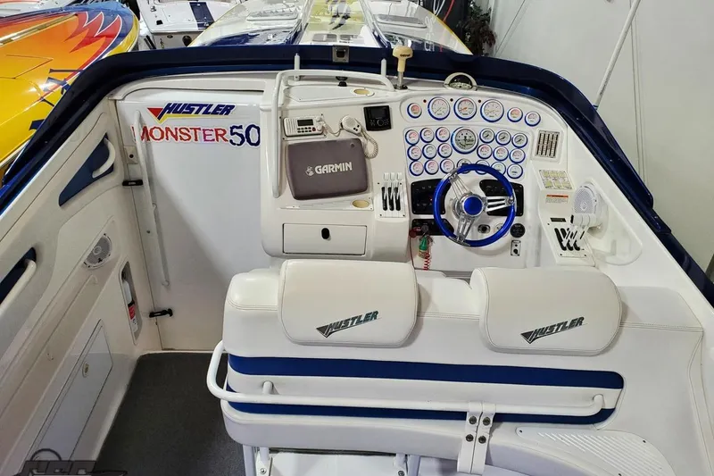 Slide: The Image of Cockpit of 2001 Hustler 50 Monster boat with Garmin navigation and dual seating. - 18