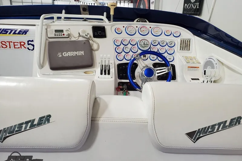 Slide: The Image of Cockpit of 2001 Hustler 50 Monster boat with Garmin navigation and multiple gauges. - 20