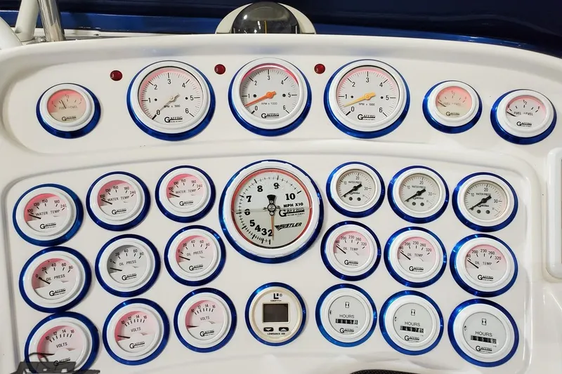 Slide: The Image of Dashboard of 2001 Hustler 50 Monster with multiple gauges and meters. - 22