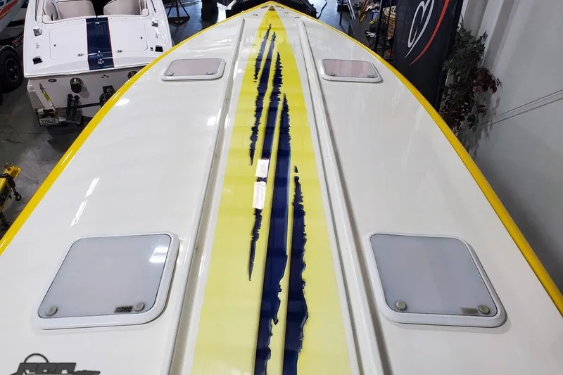 Slide: The Image of 2001 Hustler 50 Monster boat with yellow and blue stripe design, viewed from above. - 24