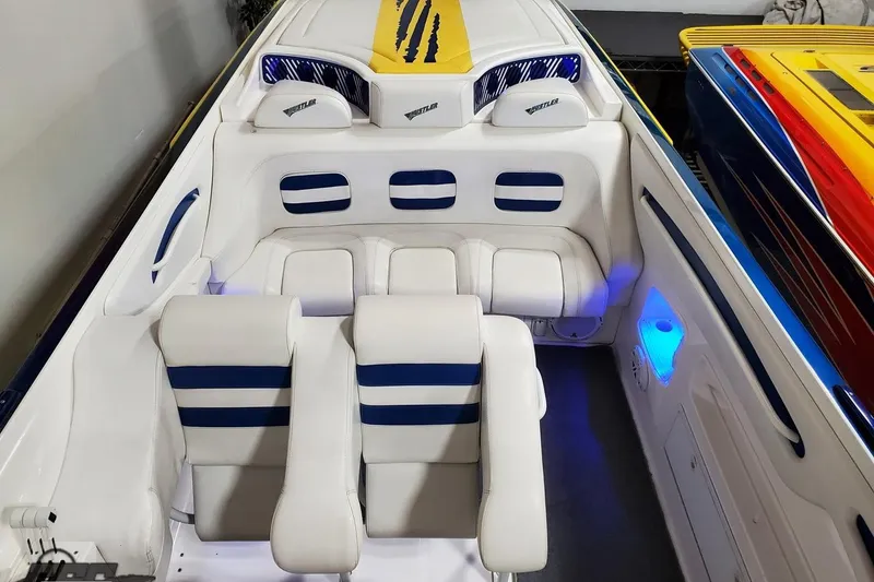 Slide: The Image of Interior of a 2001 Hustler 50 Monster boat with white and blue seating. - 27