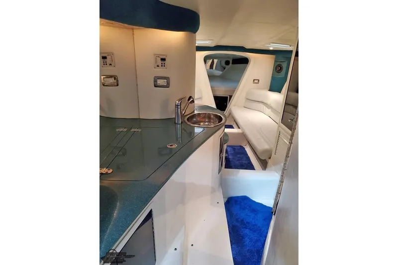 Slide: The Image of Interior of a 2001 Hustler 50 Monster boat with modern amenities and sleek design. - 28