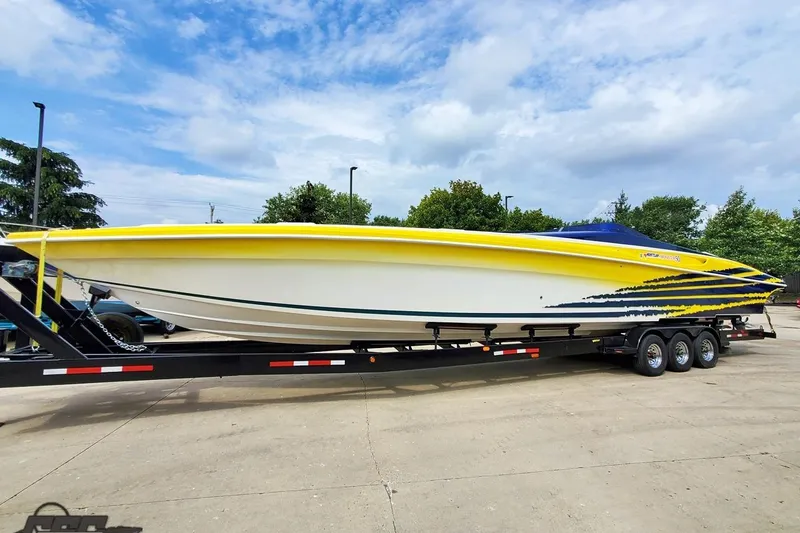 Slide: The Image of 2001 Hustler 50 Monster speedboat on trailer, featuring vibrant yellow and blue design. - 3