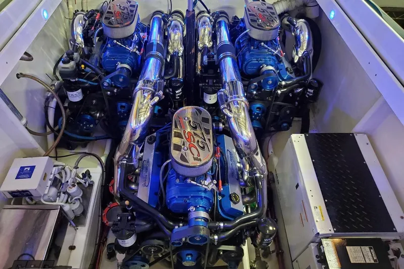 Slide: The Image of Engine compartment of a 2001 Hustler 50 Monster boat, featuring dual high-performance engines. - 38