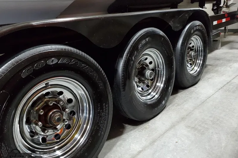 Slide: The Image of Triple axle trailer with Goodyear tires on a 2001 Hustler 50 Monster. - 8