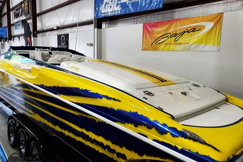 Slide: The Image of Yellow and blue 2001 Hustler 50 Monster speedboat displayed indoors. - 9