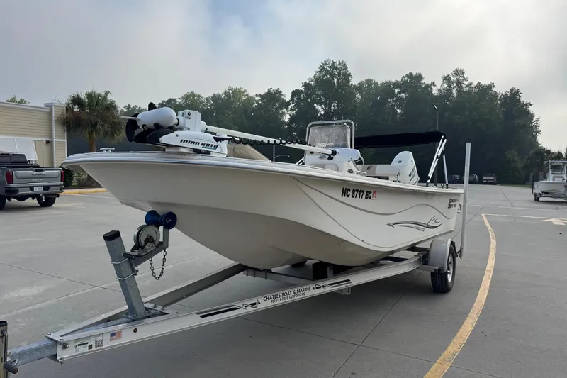 Slide: The Image of 2016 Carolina Skiff 218 DLV boat on trailer in parking lot, ready for transport. - 1