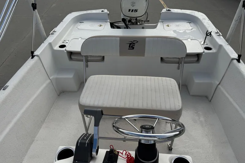 Slide: The Image of 2016 Carolina Skiff 218 DLV boat interior with steering wheel and seating. - 11