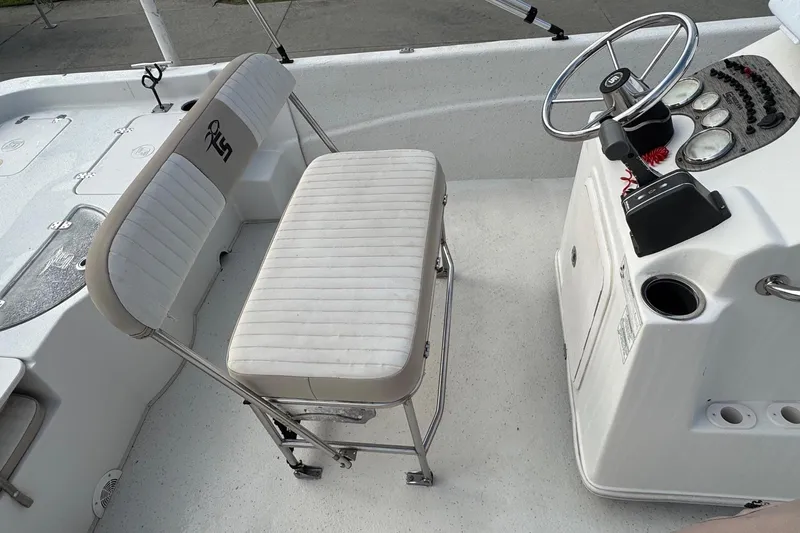 Slide: The Image of 2016 Carolina Skiff 218 DLV boat interior with steering console and seating. - 12