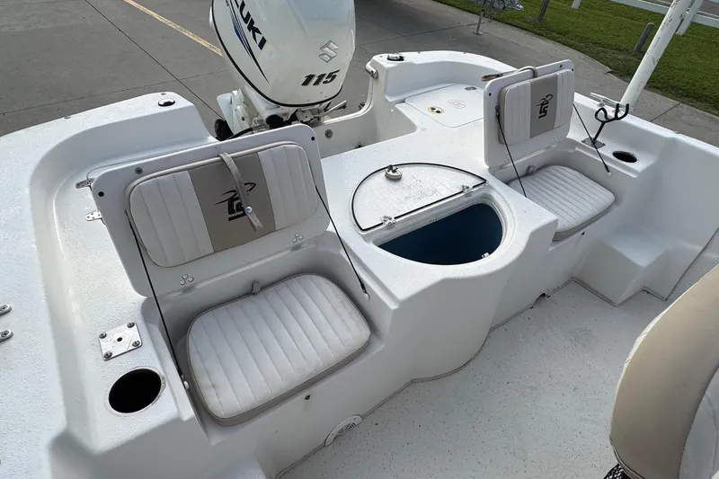 Slide: The Image of 2016 Carolina Skiff 218 DLV boat interior with seating and Suzuki 115 outboard motor. - 16
