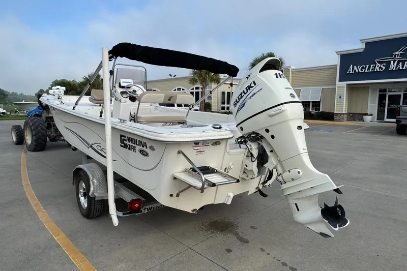 Slide: The Image of 2016 Carolina Skiff 218 DLV boat with Suzuki outboard motor at Anglers Marine. - 2