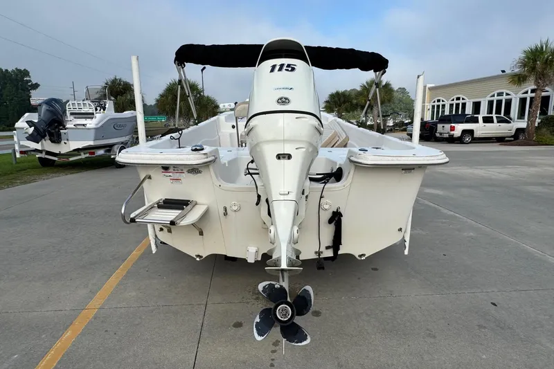 Slide: The Image of 2016 Carolina Skiff 218 DLV boat with outboard motor, parked on concrete. - 3