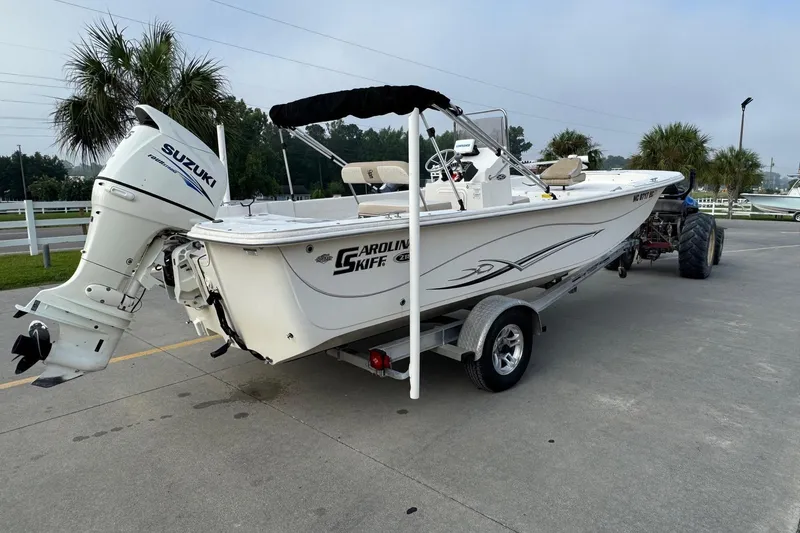 Slide: The Image of 2016 Carolina Skiff 218 DLV boat with Suzuki outboard motor on trailer. - 4
