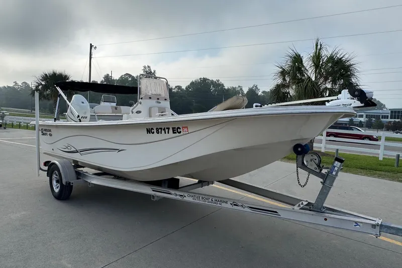 Slide: The Image of 2016 Carolina Skiff 218 DLV boat on trailer, parked outdoors. - 5
