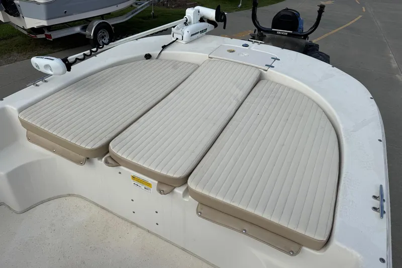 Slide: The Image of 2016 Carolina Skiff 218 DLV boat with cushioned seating and trolling motor. - 7
