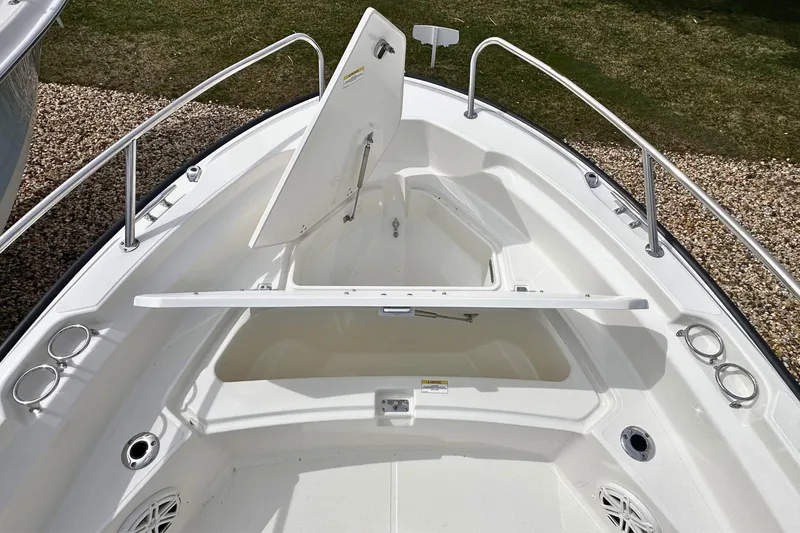 Slide: The Image of 2026 Boston Whaler 220 Dauntless boat bow with open storage compartment. - 13