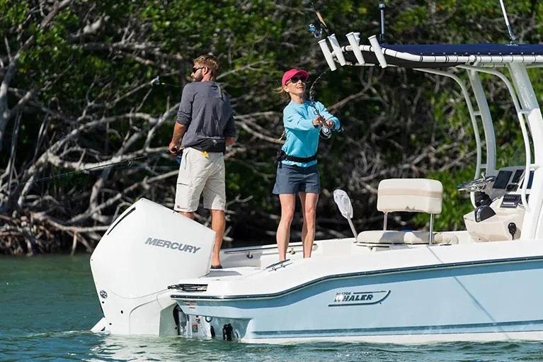 Slide: The Image of Manufacturer Provided Image: 2026 Boston Whaler 220 Dauntless boat with two people fishing in a scenic waterway. - 5