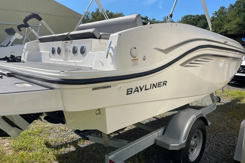 Slide: The Image of 2024 Bayliner DX 2050 boat on trailer, showcasing sleek design and modern features. - 2