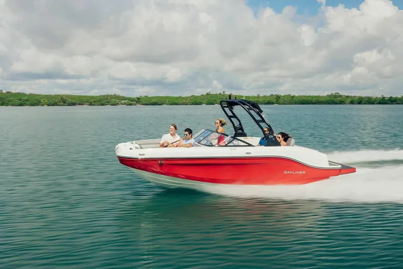 Slide: The Image of 2024 Bayliner DX 2050 speedboat cruising on a serene lake with passengers. - 7