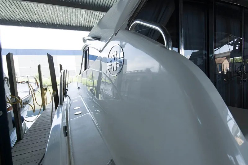 Slide: The Image of 2001 Neptunus 56 Express yacht docked in a covered marina. - 13