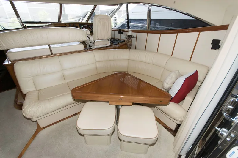 Slide: The Image of Luxurious interior of 2001 Neptunus 56 Express yacht with plush seating and wooden table. - 18