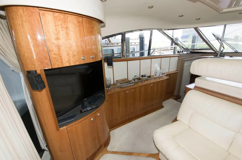 Slide: The Image of Interior of 2001 Neptunus 56 Express yacht with wood cabinetry and cream seating. - 19