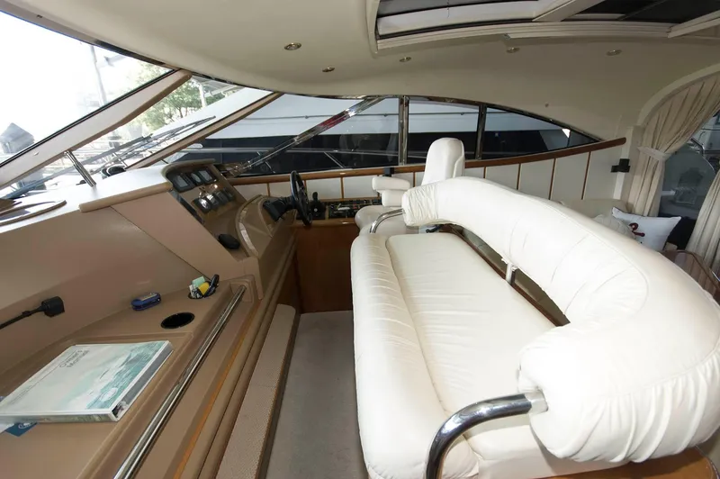 Slide: The Image of 2001 Neptunus 56 Express yacht interior with white seating and control panel. - 21