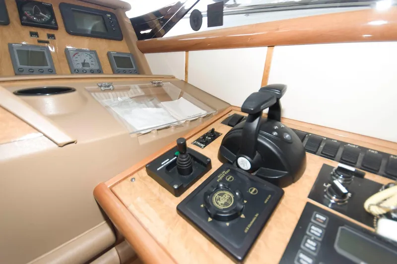 Slide: The Image of Control panel of a 2001 Neptunus 56 Express yacht, featuring navigation instruments and throttle controls. - 24