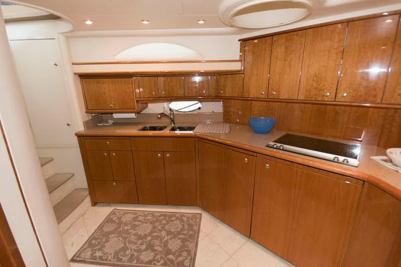 Slide: The Image of Luxurious kitchen interior of 2001 Neptunus 56 Express yacht with wooden cabinetry. - 28