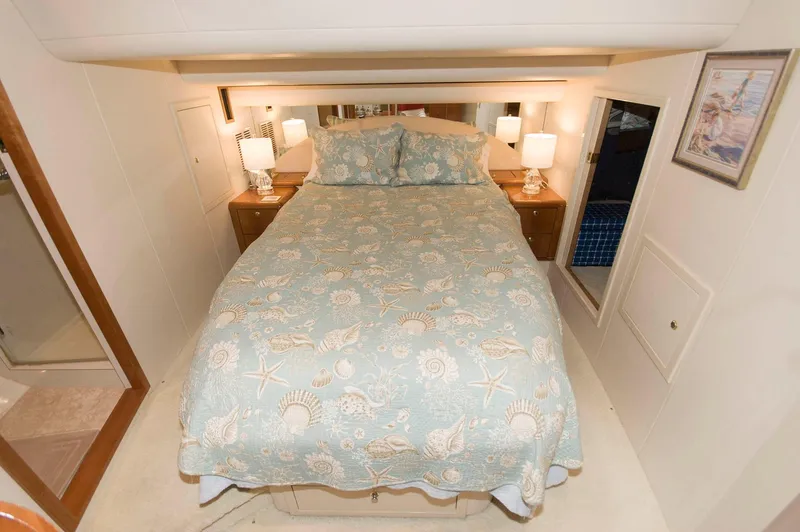 Slide: The Image of Luxurious bedroom in 2001 Neptunus 56 Express yacht with elegant bedding and ambient lighting. - 30