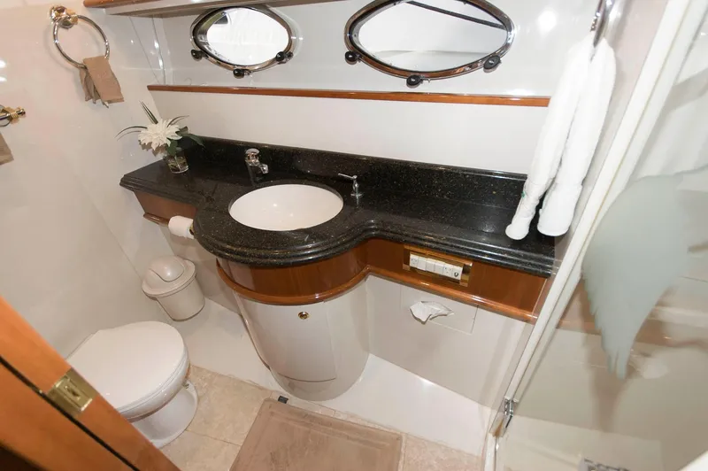 Slide: The Image of Luxurious bathroom in 2001 Neptunus 56 Express yacht with elegant fixtures and black countertop. - 33