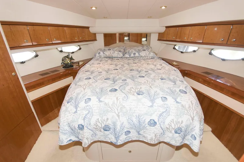 Slide: The Image of Luxurious 2001 Neptunus 56 Express yacht bedroom with elegant bedding and wood cabinetry. - 34